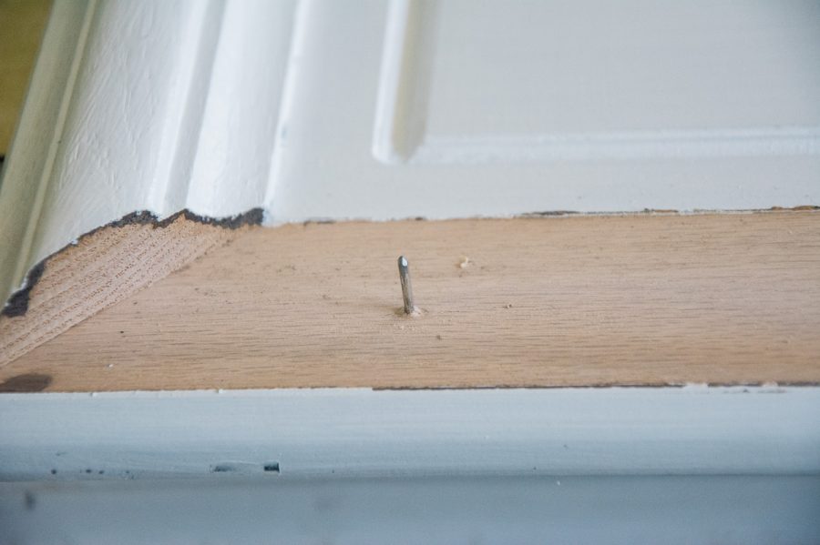 one nail sticking out of a cabinet door