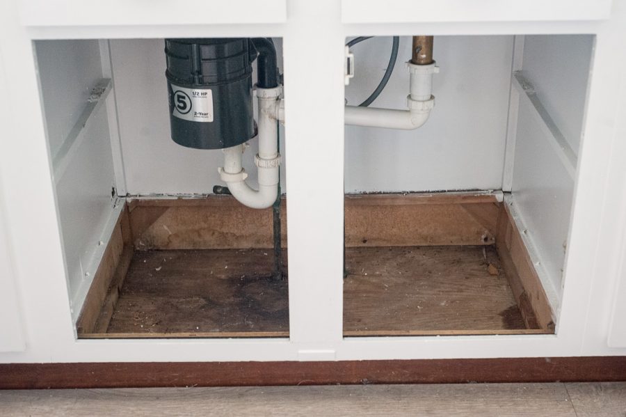 Repair cabinet floor under kitchen sink