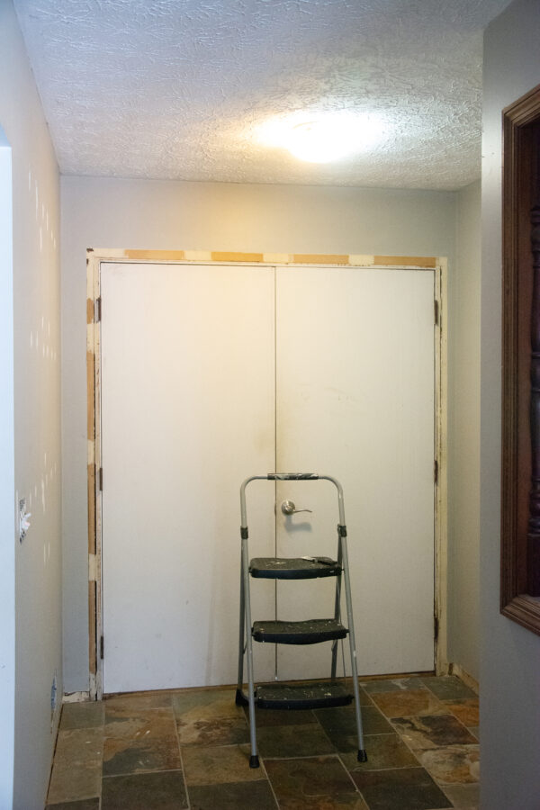 a before photo of a door with trim removed